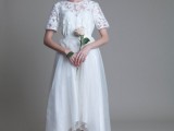 a white lace top with a high neckline and short sleeves, a layered high low skirt with a train for a romantic and chic look