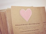 cardboard wedding invitations with embroidered pink hearts that are a unique touch and detail for the invites that make them cozy and cute