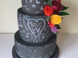a black chalkboard wedding cake with chalk detailing and bright blooms and leaves is a beautiful idea for a bold and cool wedding with a modern feel