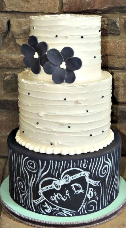 a gorgeous black and white wedding cake with textural white and a chalkboard tier, with chalking and black sugar blooms is a bold and modern solution to rock