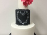 a black and white wedding cake with a black chalkboard tier, with chalking, with a bold bloom and leaves is a lovely idea for a modern wedding