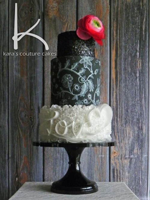 a black and white wedding cake with black chalkboard tiers, with a white textural tier, chalking, glitter and a bold pink bloom on top is amazing