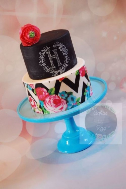a bold wedding cake with a chalkboard tier and chalking, a chevron tier with floral prints plus a bold bloom on top is amazing