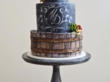 a chalkboard wedding cake with personalized chalking, a creative wood-inspired tier, sugar blooms and succulents is gorgeous for a wedding