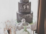 a black chalkboard wedding cake with chalking and a pink bloom on top is a fantastic idea for a modern wedding