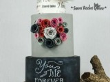 a cool wedding cake with a white, grey and black chalkboard tier, with chalking, quilling flowers and a bold paper one is pure fun