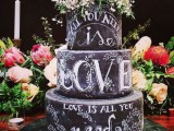 a chalkboard wedding cake with chalking and white blooms on top is a fantastic idea to rock at any wedding