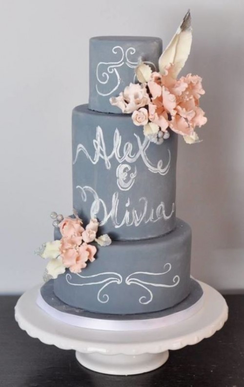 a grey chalkboard wedding cake with blush and white blooms and a feather on top plus chalked calligraphy is a gorgeous idea for a modern wedding