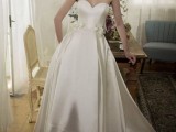 a chic strapless silk A-line wedding dress with a sweet heart neckline and a high low skirt with a train