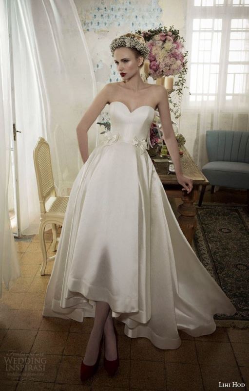 A chic strapless silk A line wedding dress with a sweet heart neckline and a high low skirt with a train