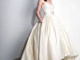 a vintage-inspired wedding ballgown with a strapless lace bodice and a champagne-colored plain full skirt wiht a train