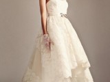 a vintage lace high low wedding dress with a sweetheart neckline and spaghetti straps plus a train and a bow on the sash