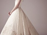a sophisticated lace wedding ballgown with a sleeveless bodice and a skirt of white and tan lace with a long train is amazing