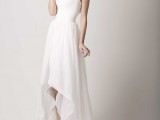 a romantic lace and ruffle high low wedding dress with a sweetheart neckline, lace cap sleeves and a skirt with a train