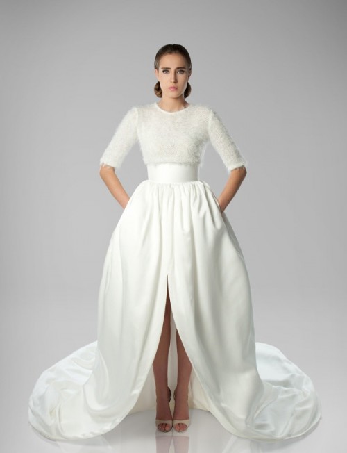 a dramatic wedding dress with an embellished bodice, a high neckline, short sleeves and a plain full skirt with a train and a front slit is bold