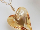 a beautiful yellow crystal heart pendant on gold chain is a statement accessory for a bride, it will give your look a catchy touch both with its shape and color