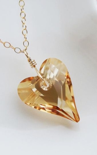 a beautiful yellow crystal heart pendant on gold chain is a statement accessory for a bride, it will give your look a catchy touch both with its shape and color