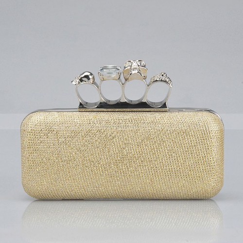 a gold fabric clutch with gorgeous rings isntead of a handle is a fantastic idea for a modern and edgy bride, it will bring interest to the look