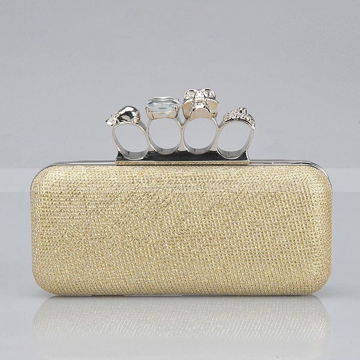 A gold fabric clutch with gorgeous rings isntead of a handle is a fantastic idea for a modern and edgy bride, it will bring interest to the look