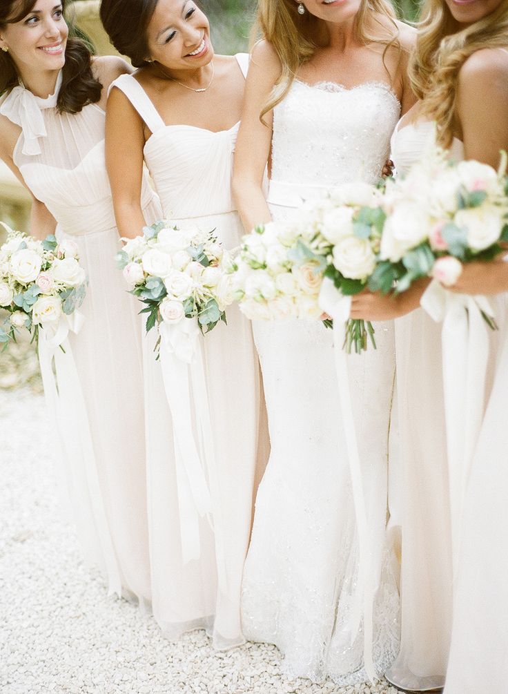 Mismatching white fitting maxi bridesmaid dresses are lovely for an elegant spring or summer wedding in neutrals