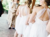 matching white over the knee A-line bridesmaid dresses with cutout backs are gerat for a casual modern wedding