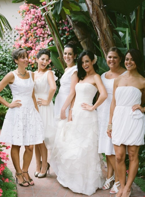 mismatching white plain, lace and pleated bridesmaid dresses for a modern tropical wedding