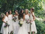 matching A-line midi bridesmaid dresses with halter necklines and pleated skirts plus white shoes for a modern spring or summer wedding