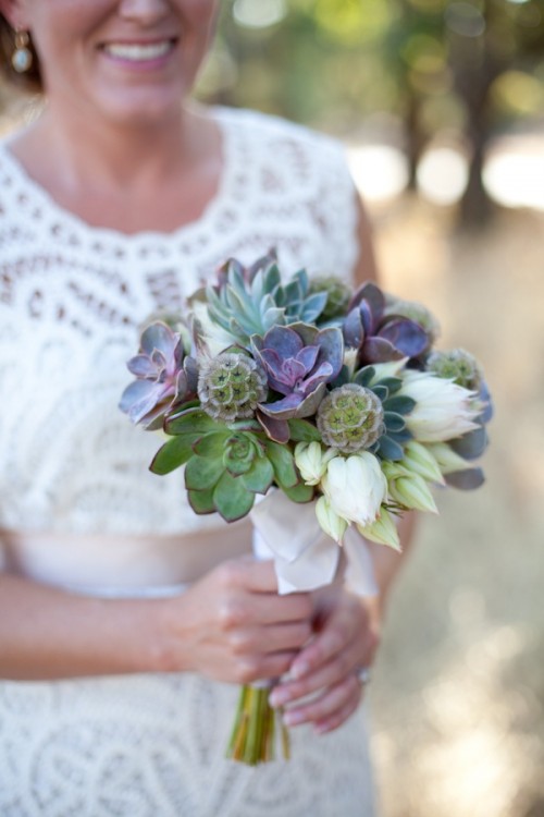 a white wedding bouquet with various succulents and seed pods is a stylish and catchy idea for a neutral wedding