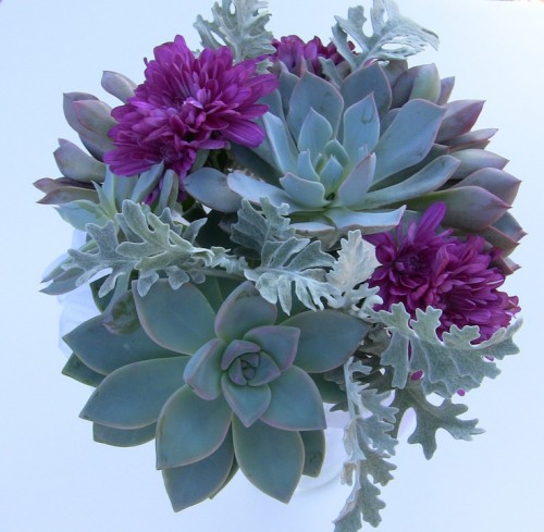 a succulent wedding bouquet with pale leaves and purple blooms is a catchy idea thta will fit a fall wedding
