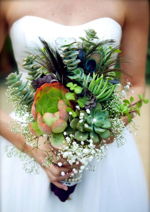 a creative wedding boquuet of succulents, a peacock feather, eucalyptus, baby's breath is a unique idea for those who love bold bouquets