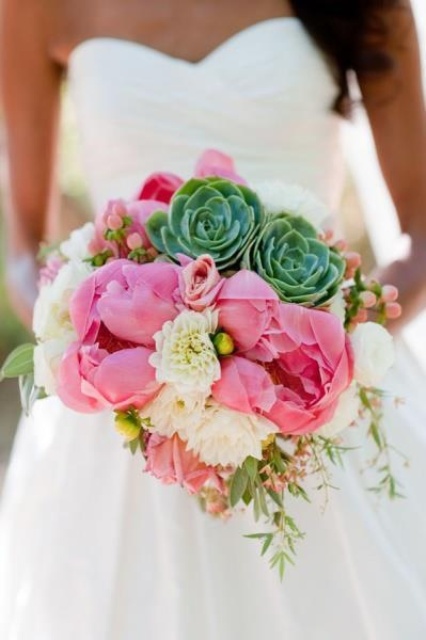a wedding bouquet of pink peonies, white blooms, berries and succulents is a catchy idea with pkenty of color