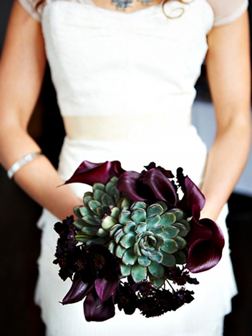 a unique wedding bouquet of a large succulent surrounded with deep purple callas is a lovely idea for a fall wedding