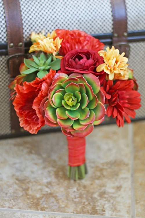 a colorful wedding bouquet of red and yellow blooms and succulents is a bold idea for a summer wedding
