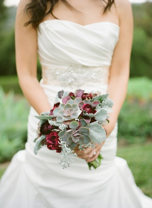 a wedding bouquet of succulents, burgundy blooms and pale leaves is a catchy idea for a fall wedding