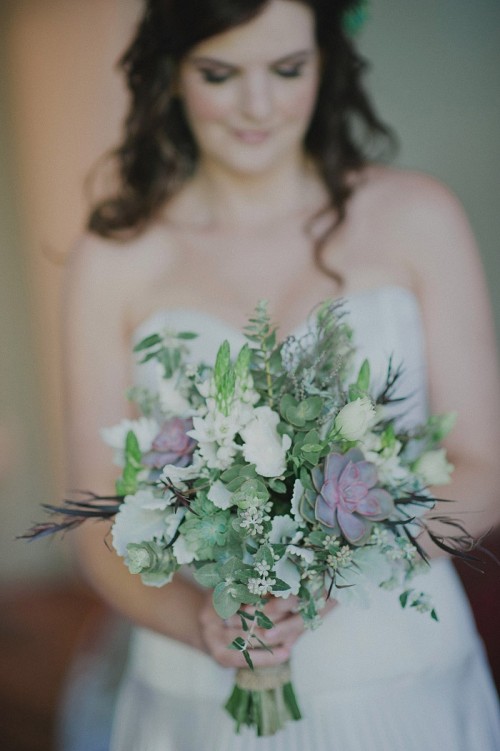 a white wedding bouquet with succulents, some green and purple fillers, pale greenery is a stylish idea for a modern bride