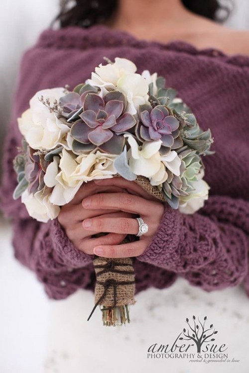 a catchy wedding bouquet of white blooms and dark succulents plus some fillers is a lovely idea for a winter wedding