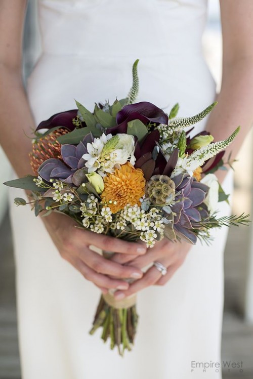 a whimsical wedding bouquet with dark callas and purple succulents, blooming fillers, astilbe and greenery is idea for a fall wedding
