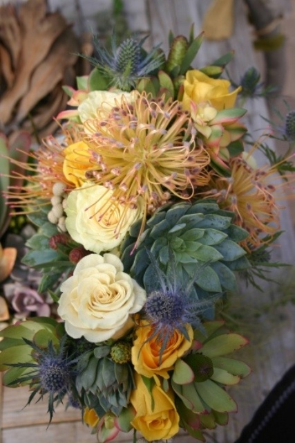 a bright wedding bouquet with yellow roses and pincushion proteas, succulents and thistles is a cool and bold idea for a modern bride
