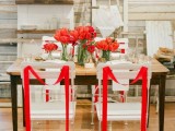 red tulip arrangements and red ribbons on the chairs are a great combo for a modern wedding with red in the color palette