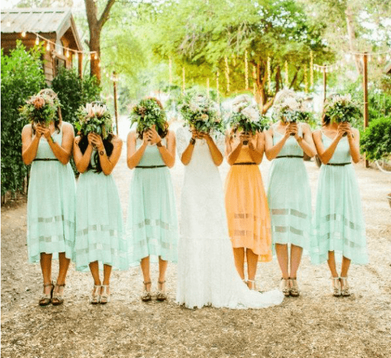 Matching mint dresses for everyone and a marigold one for the maid of honor to brighten up your summer color palette