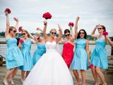 mismtaching light blue bridesmaid dresses and a strapless red one for the maid of honor
