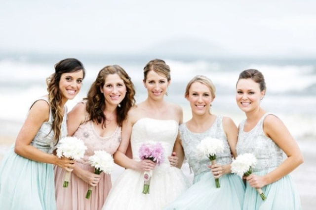 Matching embellished mint green gowns for the bridesmaids and a blush embellished dress for the maid of honor