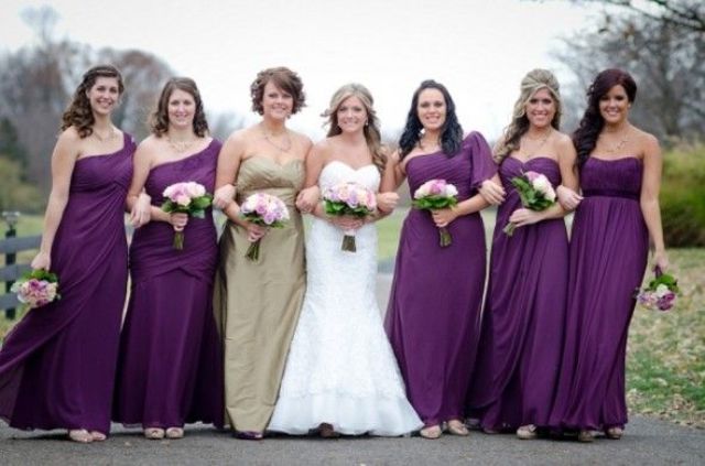 Mismatching purple maxi dresses for bridesmaids and a strapless gold maxi gown for the maid of honor