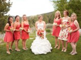 mismatching coral knee bridesmaid dresses and a bright floral gown for the maid of honor