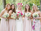 blush illusion neckline maxi dresses for the bridesmaids and a bright floral gown for the maid of honor
