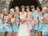 matching light blue short bridesmaid dresses and a light pink gown for the maid of honor