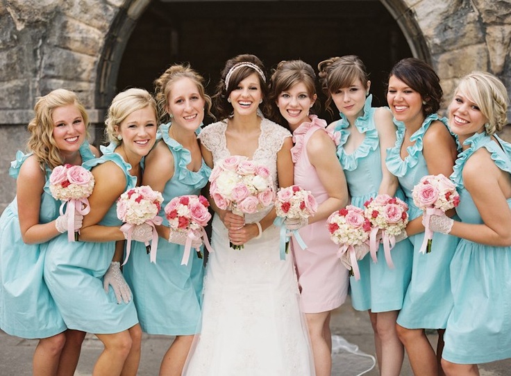 Matching light blue short bridesmaid dresses and a light pink gown for the maid of honor