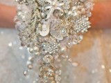 a cascading brooch winter wedding bouquet done in white and silver is a gorgeous glam solution for a winter bride