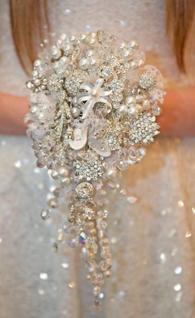 a cascading brooch winter wedding bouquet done in white and silver is a gorgeous glam solution for a winter bride