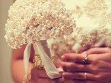 a small and elegant wedding bouquet of white pearls will fit many bridal looks and styles and will bring vintage elegance to it